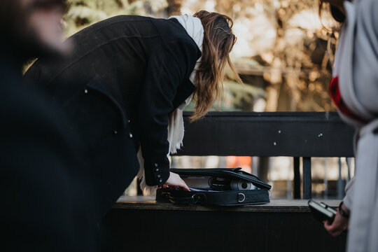 Person bending over bench with VR headset, concept of modern technology in daily life.