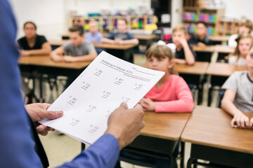 Classroom: Teacher Holding Math Test In Front Of Class