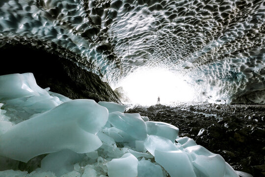 woman standing in beautiful ice cave