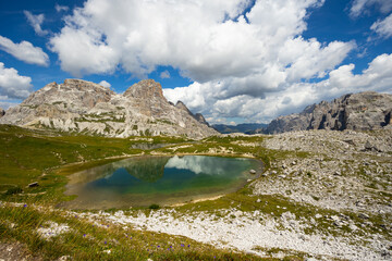 Breathtaking natural landscape with small alpine lakes Laghi dei Piani with emerald waters nestled amidst Italian Dolomite mountains with towering rocky peaks 