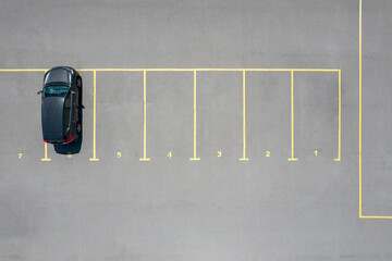 Aerial view of auto standing on parking place on number six