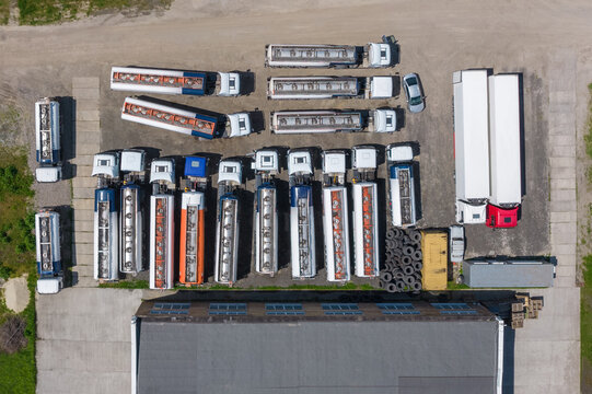 Aerial view of tank cars and cargo trucks near industrial building