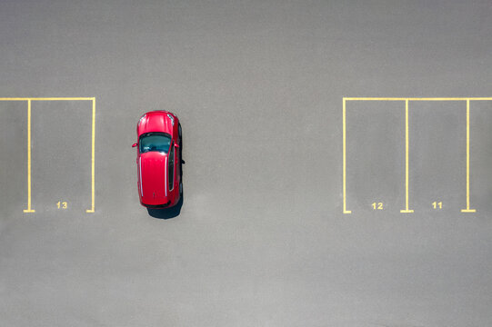 Drone view of luxury red car parked on not designated space
