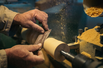 Woodworker using carpentry lathe