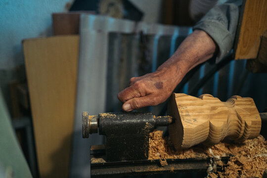 Male woodworker using lathe machine
