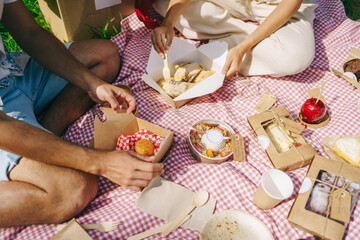 Crop friends enjoying food during picnic