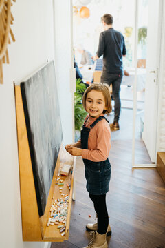 Girl writing on a blackboard