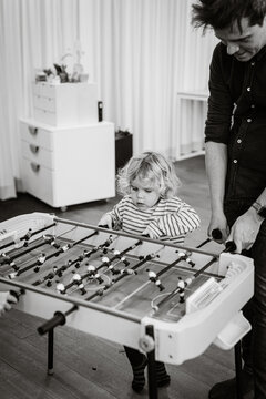 Father and daughter playing foosball