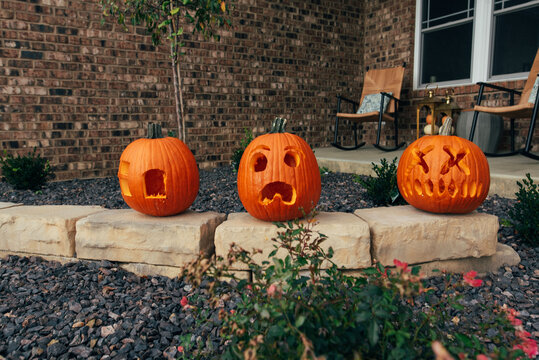 Three oversized pumpkins on display for Halloween. 