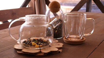 Woman fills teapot with fragrant tea leaves Experience soothing ritual perfect for relaxation and rejuvenation with herbal tea from teapot Feel the taste of freshly brewed aromatic tea in teapot