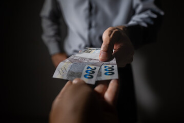 The picture represents cases of corruption and bribery in many different cases such as politics, football, business in Brazil, Europe and the USA. This could be in dollar, euro or brazilian real.