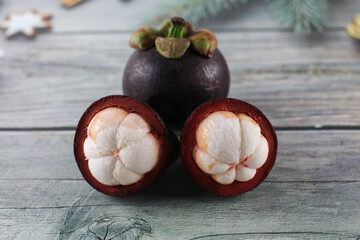Mangosteen isolated on wooden background. Known as The Queen of Fruits, asia fruits concept. Sweet...