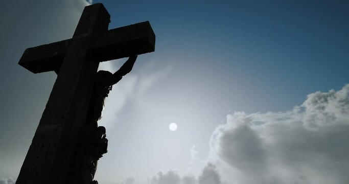 Fast-moving clouds on the background of the blue sky fly over the crucifix, which is located on Mount Calvary. Concept of atonement, religious holidays. Easter. Time lapse. Hi-quality 3d render.