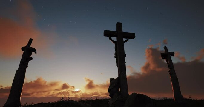 Easter concept. The rays of the setting sun break through the fleeting clouds that fly across the sky above Mount Calvary, where three crosses are located.