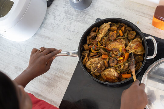 plantains with chicken and vegetables in frying pan, cooking bananas