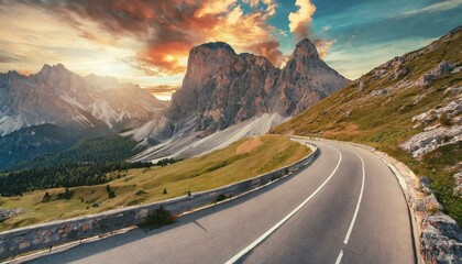 Mountain road at colorful sunset in summer. Dolomites, Italy. Beautiful curved roadway, rock - obrazy, fototapety, plakaty