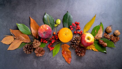 autumn decoration concept made from autumn leaves and autumn fruit on dark background.