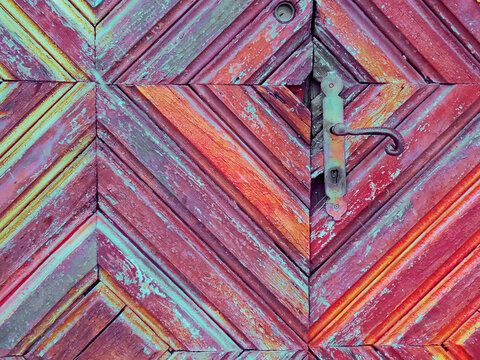 Rusty lock on the faded wooden door of an old medieval fortress.