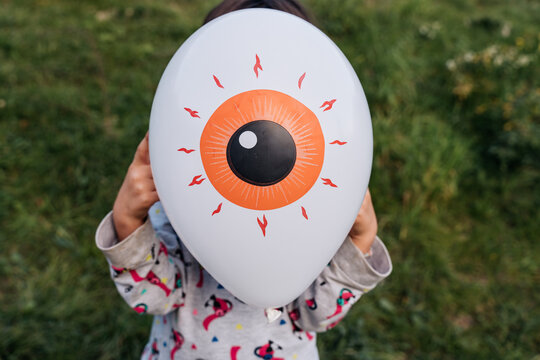 Kid with eye balloon in halloween