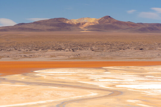 Aerial shot of the red lake in uyuni salt flat