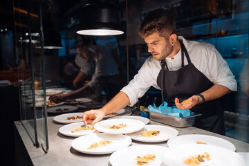 Male chef doing plating for banquet