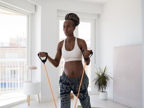 Fit black woman in expectancy training with band