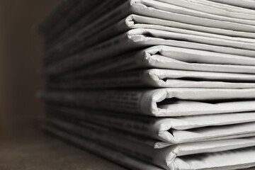 Stack of newspapers on table, closeup. Journalist's work