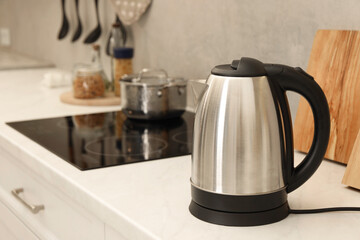 Modern electric kettle on counter in kitchen