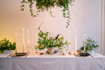Festive Christmas table decoration arrangement with burning candles