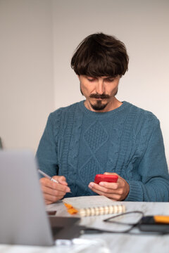 A man working on a laptop from home
