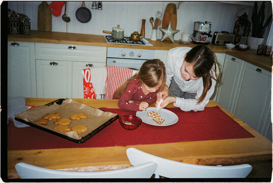 Mother and daughter preparing Christmas cookies, ugc
