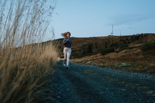 Girl running on the mountain trail