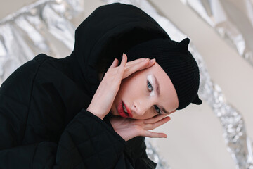 Young woman with makeup wearing black hat with horns during Halloween