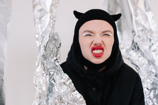 Excited woman in Halloween costume sticking out tongue