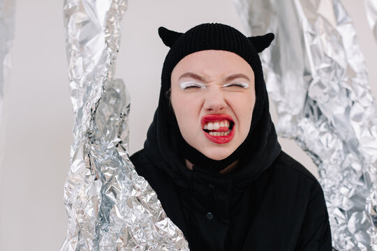 Excited woman in Halloween costume sticking out tongue