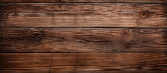 A close-up view of a weathered wooden wall with a prominent brown stain running down the grain. The texture and color of the wood are highlighted by the dark stain.