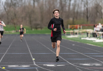 Highschool boy running track