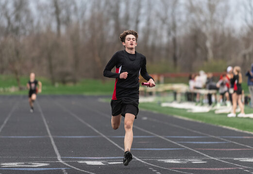 Highschool boy running track