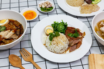 Stewed pork leg with boiled egg and rice on a plate.