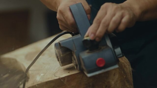 close up view of using an electric hand planer