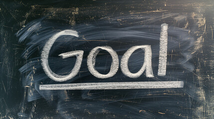 A chalkboard with the word "goal" written on it in white chalk