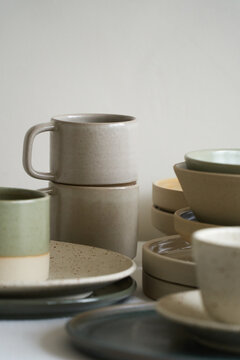 Stacked Stoneware Mugs and Plates

