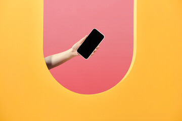 Woman's hand presenting modern smartphone with blank screen