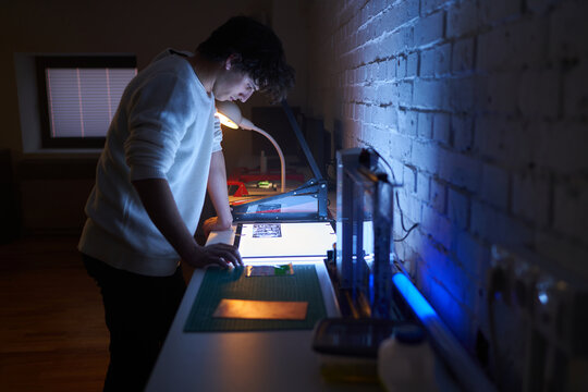 Technician looking at circuit board diagrams