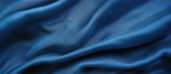 A detailed view of a blue fabric cloth background, showcasing its textured surface in an alluring manner. The fabric is smooth and vibrant, with intricate patterns that catch the eye.