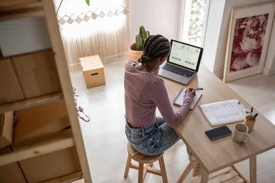 Female manager writing down data on planner