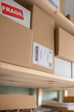 Carton containers with labels on shelves