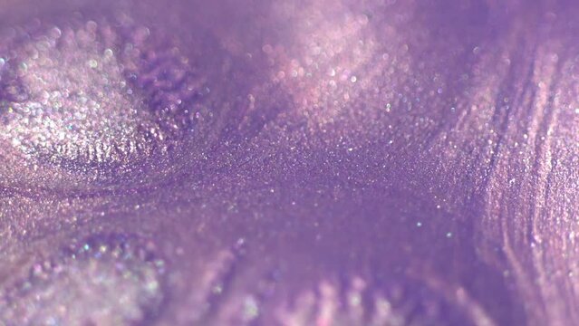 Purple color metallic fluid background texture. Beautiful magical Christmas glitter and bokeh