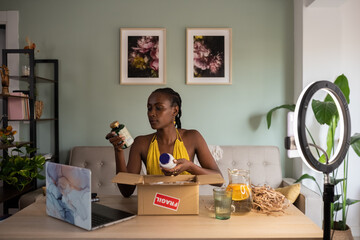 Black female influencer unpacking dietary supplements