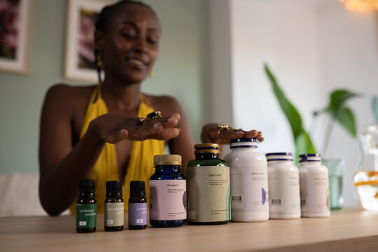 Woman putting hands above bottles with supplements